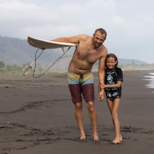 Father and daughter posing after their surf